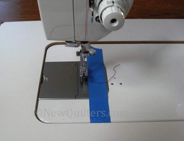 https://newquilters.com/wp-content/uploads/2012/02/Tape-Seam-Guide-on-Sewing-Machine-1.jpg