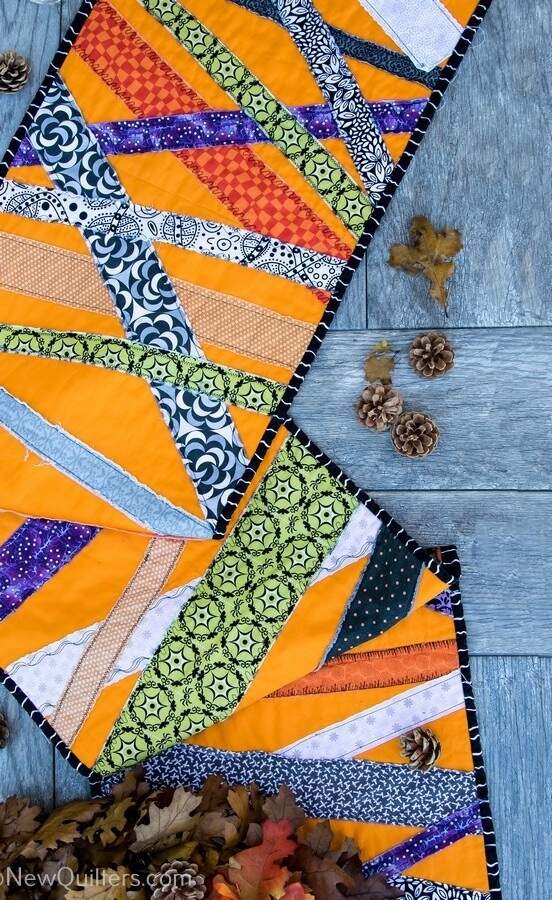 Get inspired to make a quick and easy Halloween table runner with this gallery of photos from the one we made. NewQuilters.com #halloweenquilt, #tablerunnerquilt, #tabletopperquilt