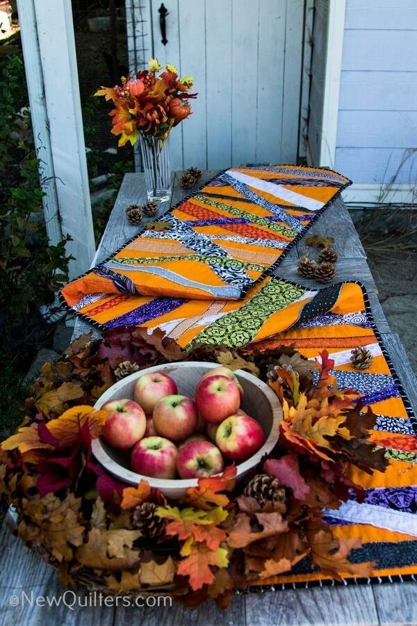 Get inspired to make a quick and easy Halloween table runner with this gallery of photos from the one we made. NewQuilters.com #halloweenquilt, #tablerunnerquilt, #tabletopperquilt