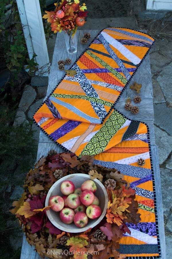 Get inspired to make a quick and easy Halloween table runner with this gallery of photos from the one we made. NewQuilters.com #halloweenquilt, #tablerunnerquilt, #tabletopperquilt