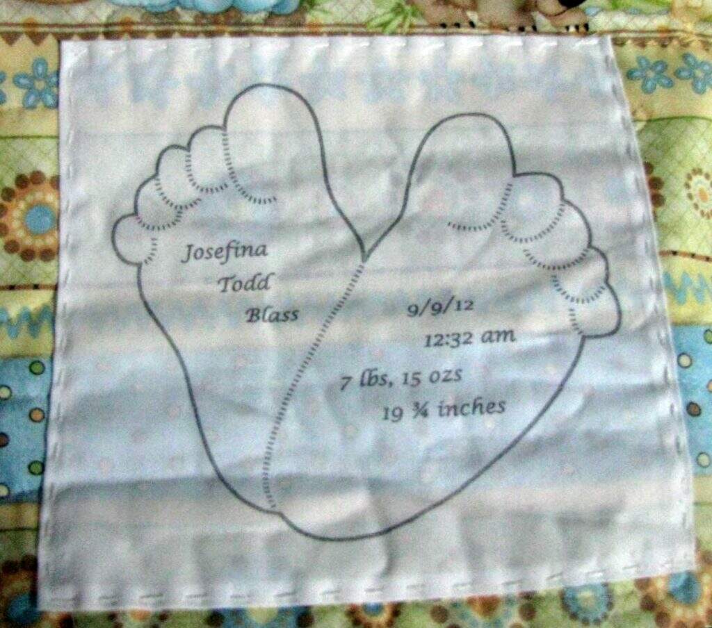 Photo of quilt label with baby feet drawing